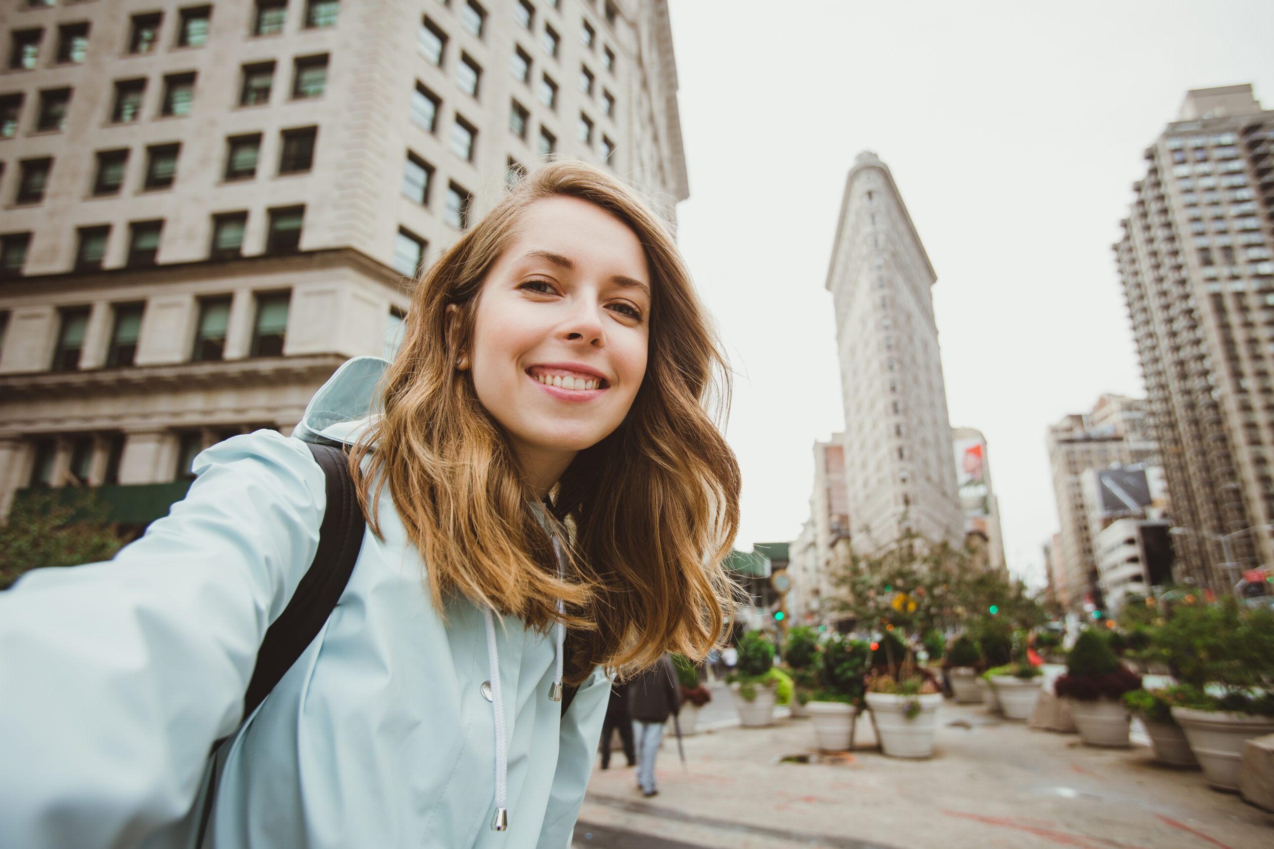 Happy,Young,Woman,Takes,Selfie,Photo,Near,Flat,Iron,Building