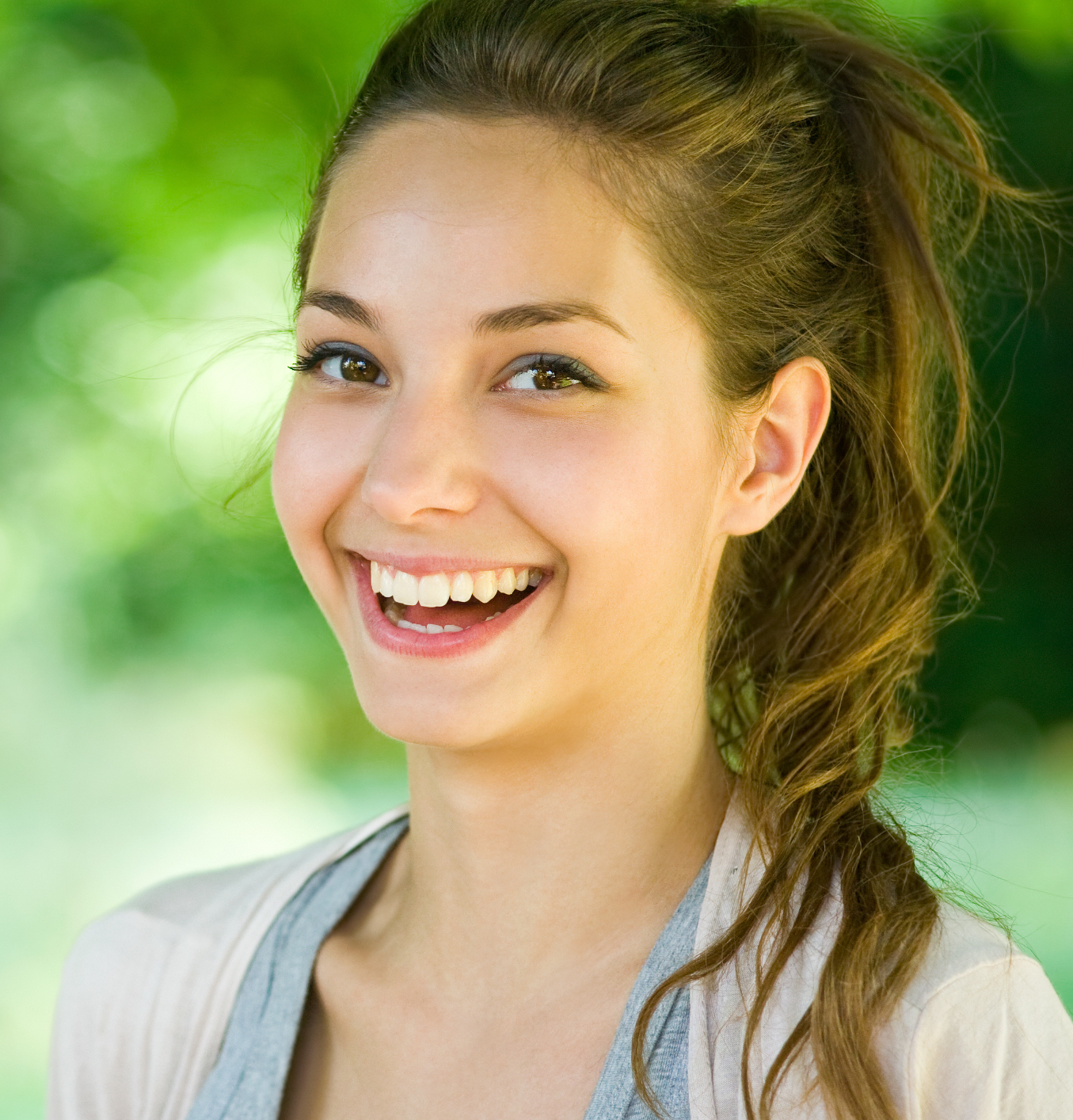 Outdoors portrait of beautiful young brunette girl.